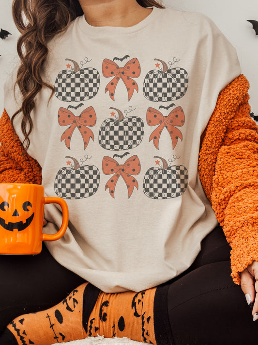 Coquette Halloween pumpkins and bows tshirt, fall tshirt, cute fall tshirt, coquette pumpkin Tshirt , fall tshirt heather sand unisex tshirt